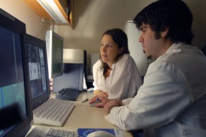 Technicians Tim Belisle and Tricia Locascio of Nuclear Medicine in the PET/CT control room.