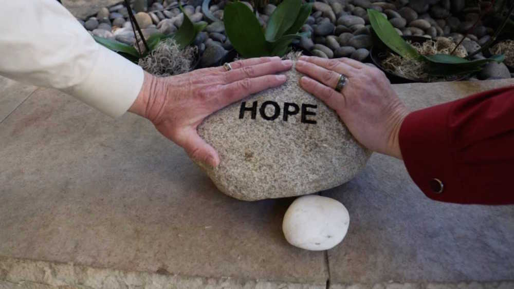 The couple exchanged wedding vows in the Healing Garden while holding the Hope rock, a familiar piece to many who frequent the tranquil garden.